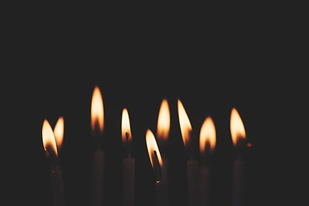 nine lighted candles in the dark thumbnail