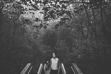 woman standing stairs surrounded with trees thumbnail