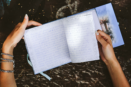 Woman reading a diary by the table thumbnail