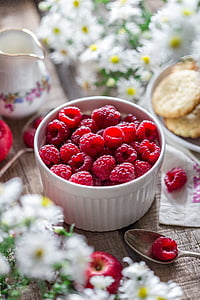 selective focus photography of raspberries in white ceramic bowl thumbnail