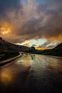 landscape photography of white and black concrete house near black concrete road thumbnail