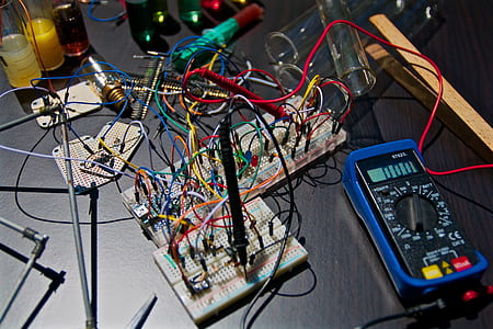 close-up photography of blue multimeter and assorted-color electric components thumbnail