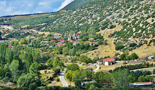 aerial view of village near hills during daytime thumbnail