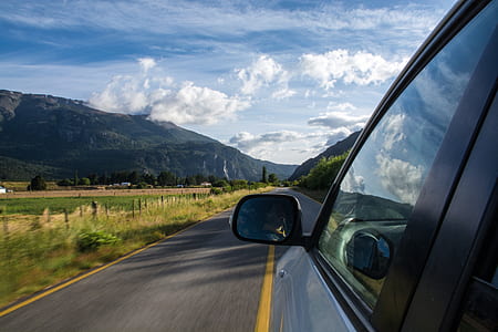 white car on road at daytime thumbnail