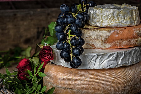 black grapes beside red roses in bloom thumbnail