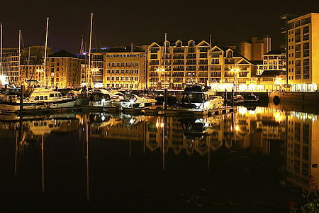 boats parked near building during golden hour thumbnail