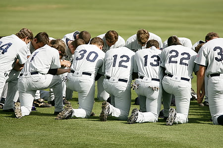baseball players gathered on field thumbnail