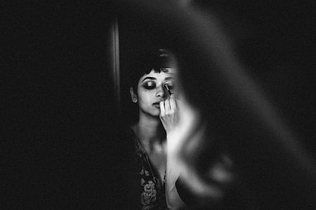 woman facing mirror photography thumbnail