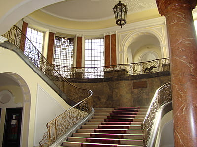 photo of white and brown staircase inside white room thumbnail