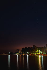 Starry sky at night over the marina, Izola, Slovenia thumbnail