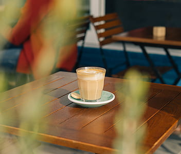 clear cup filled with coffee on saucer thumbnail