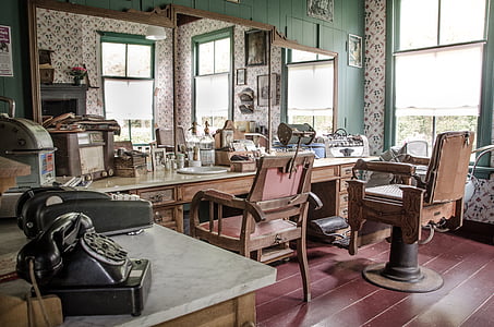 two brown wooden barber chairs thumbnail