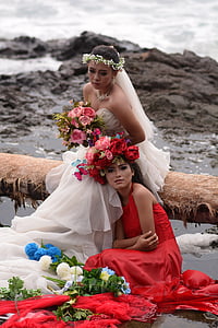 two women in white and red wedding dresses sitting on the bench thumbnail