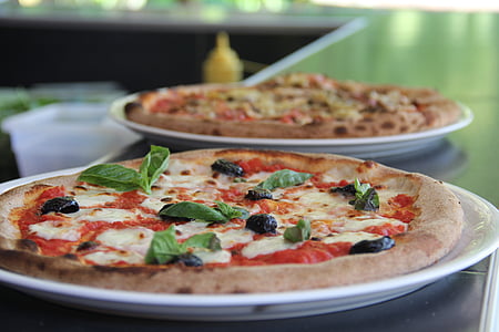 selective photography of pizza on white ceramic plate thumbnail