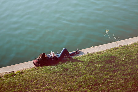 person laying down near body of water thumbnail