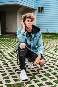 man about to kneel on grey concrete block nearby house thumbnail