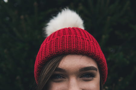 smiling woman wearing red and white bobble hat thumbnail