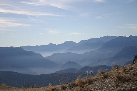 aerial photography of mountains under white sky during daytime thumbnail