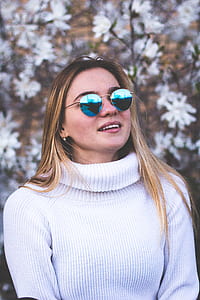 woman wearing white turtleneck sweater and blue-lens sunglasses thumbnail