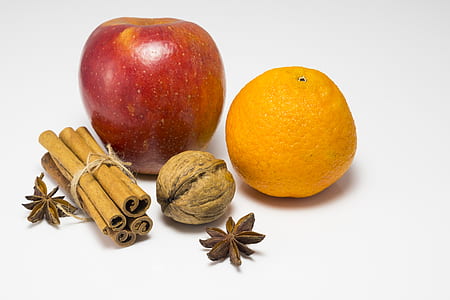 walnut beside red apple and orange fruit thumbnail