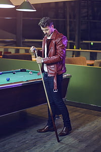 man holding cue stick standing beside table pool thumbnail
