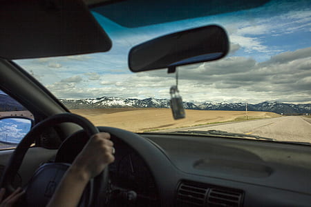 person sitting on drivers seat inside car thumbnail