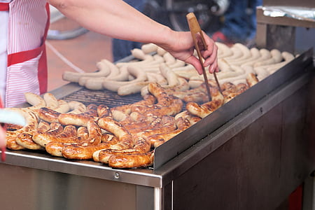 person grilling sausages thumbnail