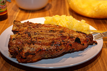 roasted steak on white plate close-up photography thumbnail