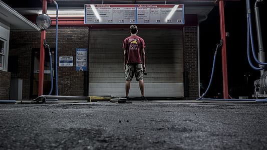 man standing on gray pavement thumbnail