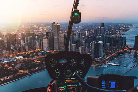 aerial photography of city building near body of water thumbnail