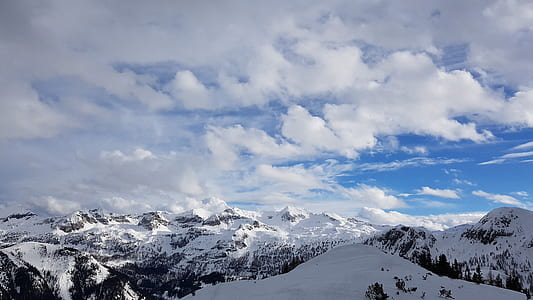 snow covered mountain under white clouds and blue sky at daytime thumbnail