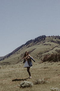 woman wearing black top standing on mountain thumbnail