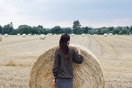 Woman Standing in Front of Hay thumbnail