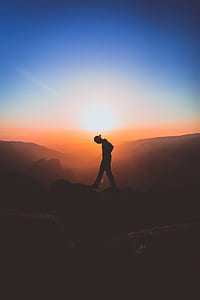 person standing on top of the mountain photography thumbnail