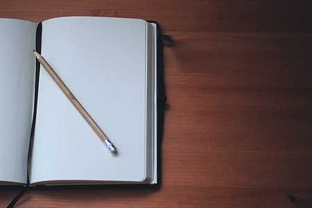 Open sketch book and pencil on desk thumbnail