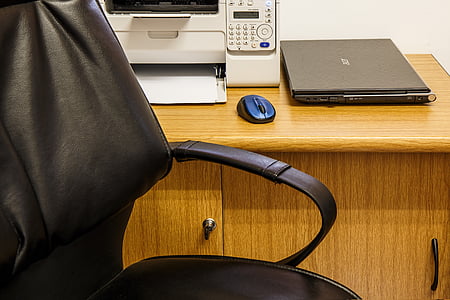 closed Acer laptop near at printer and optical mouse on table thumbnail