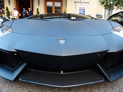 blue Lamborghini parked outside building thumbnail