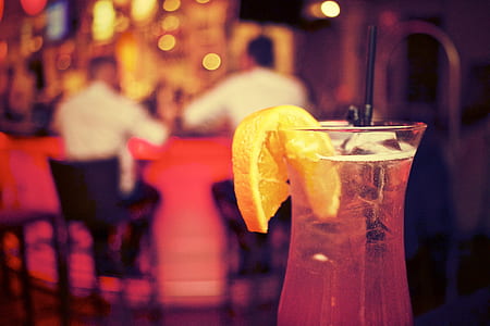 selective photography of beverage on glass with slice of lemon thumbnail
