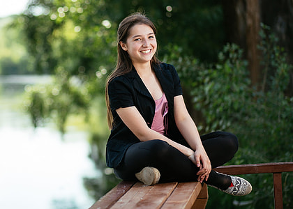 woman sitting on brown wooden bench thumbnail