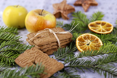 four cookies with tie beside two yellow apple fruits thumbnail