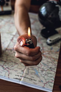 Person Holding Black Disposable Lighter thumbnail