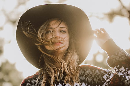 selective focus photography of woman in white, black, and red sweater during daytime thumbnail