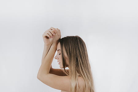 woman leaning on white wall thumbnail