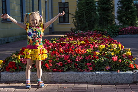 girl wearing Minnie Mouse-printed dress behind flower lot thumbnail