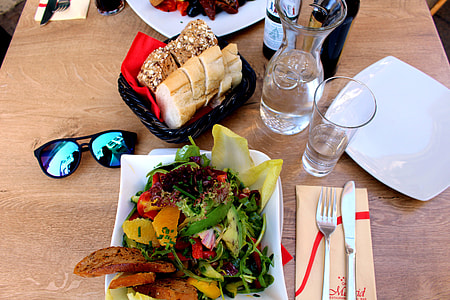 vegetable foods and baked bread beside pitcher and glass on brown wooden table thumbnail