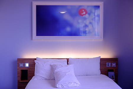 white bed linen with three white pillows thumbnail