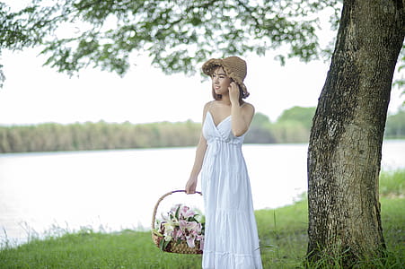 Smiling Woman Carrying Basket of Flowers thumbnail
