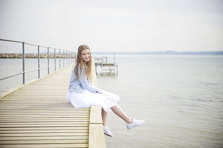 woman sitting on beach dock thumbnail