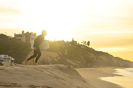 man holding surfboard thumbnail