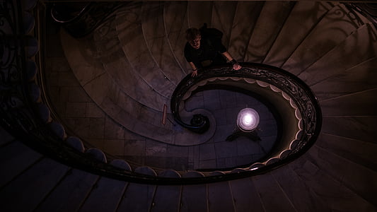 man holding stairway handle and looking up thumbnail